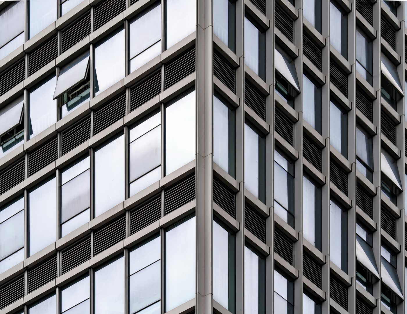 Reflective glass commercial office building representing portfolio-scale asset context