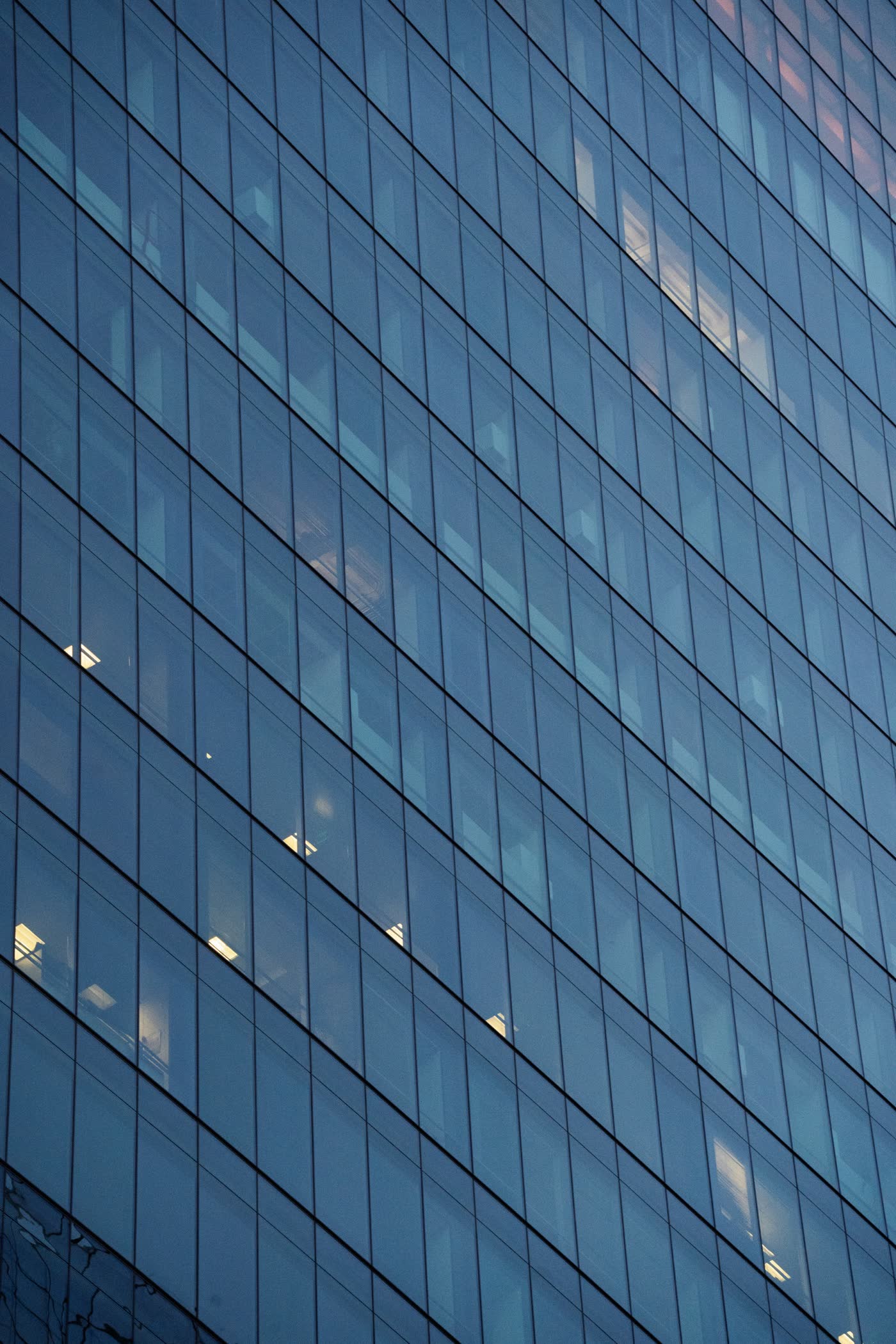 Geometric glass facade of a modern commercial office tower